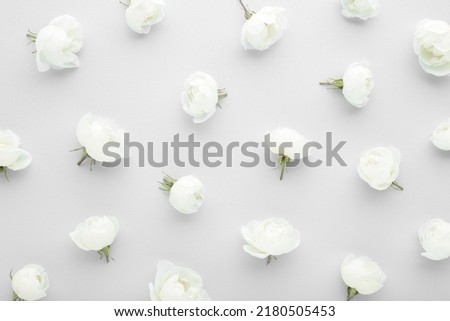 Fresh white roses on light gray table background. Beautiful flower pattern. Closeup.