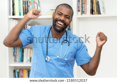 Cheering african american mature nurse or doctor at office of hospital