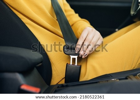 Woman Hand Fastening Car Safety Seat Belt. Protection Road Safety Snap Driving. Driver Fastening Seatbelt In Car. Woman Car Lap Buckling Seat Belt Inside In Vehicle Before Driving. Royalty-Free Stock Photo #2180522361