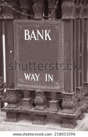 Bank Entrance Sign in Urban Setting in Black and White Sepia Tone