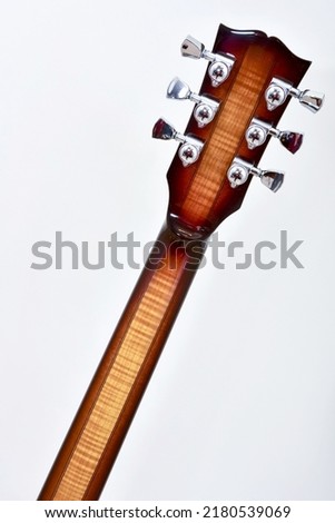  reverse side of a six string guitar neck on a white background