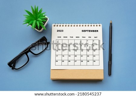 September 2023 desk calendar on blue background. Directly above. Flat lay. Copy space. Royalty-Free Stock Photo #2180545237