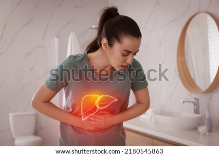 Sick woman suffering from pain in bathroom and illustration of unhealthy liver. Hepatitis disease Royalty-Free Stock Photo #2180545863