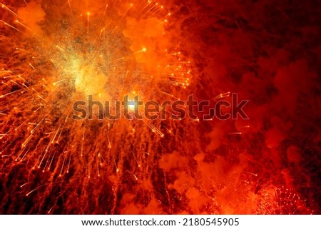 A flash of bright, red, festive fireworks. Background picture.