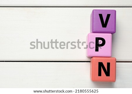Color cubes with acronym VPN on white wooden background, flat lay. Space for text