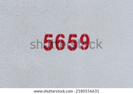 Red Number 5659 on the white wall. Spray paint.
