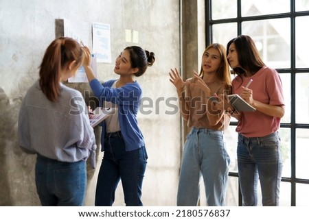 Creative young Asian business woman meeting to plan events. Take note of the job description to make a new job offer. Royalty-Free Stock Photo #2180576837