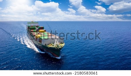 Aerial front view of a container cargo vessel traveling over the ocean with copy space as a banner Royalty-Free Stock Photo #2180583061