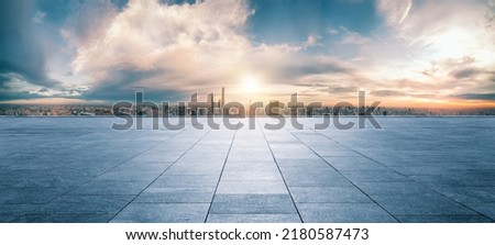 Panoramic sky and building with empty concrete square floor Royalty-Free Stock Photo #2180587473