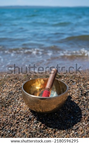Singing (Tibetan) bowl on the shore of the lake.
