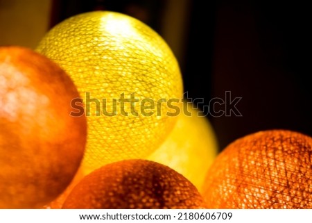 Yellow orange glowing balls. Orange glowing balls. Yellow glowing balls. Glowing balls on garland Royalty-Free Stock Photo #2180606709
