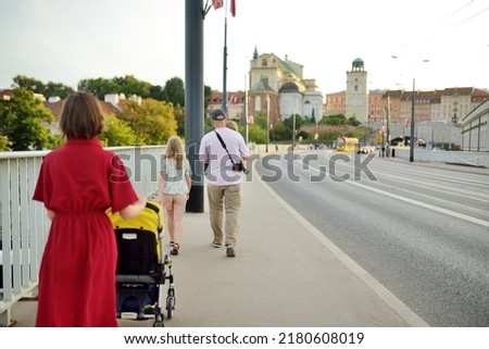Father and his three kids explore beautiful streets of Warsaw's Old Town. Children having fun outdoors in Polish capital. Family walks in summer.