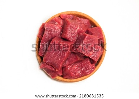 Fresh tasty square shape beef meet in wooden bowl