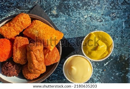 Closeup of bowl traditional typical dutch breadcrump fried meat based finger street food snack (bitterballen garnituur),  mayonnaise and mustard sauce dips - Netherlands Royalty-Free Stock Photo #2180635203