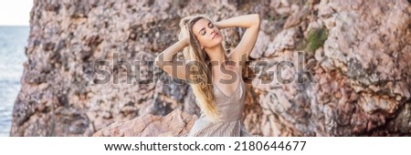 BANNER, LONG FORMAT Woman tourist against the backdrop of rocks in Montenegro. Panoramic summer landscape of the beautiful green Royal park Milocer on the shore of the the Adriatic Sea, Montenegro