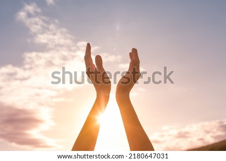 hands up to the sun light sky feeling thankful and grateful 
