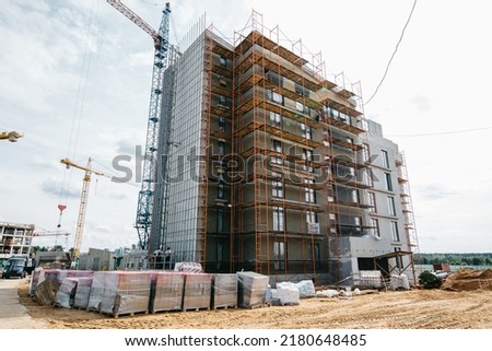 scaffolding at the construction site of stylish apartment buildings, yard area. High quality photo
