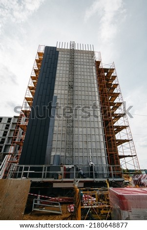 scaffolding at construction site with cranes and machinery for builders. High quality photo