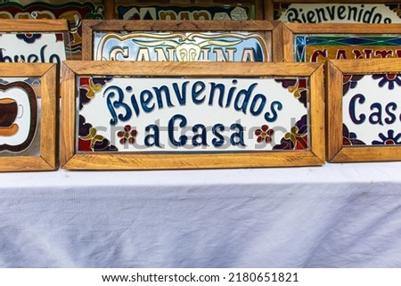 Welcome home colorful sign written in spanish that says "bienvenidos a casa" at sale in a street market at Los Sapos magic town in Puebla city, Mexico