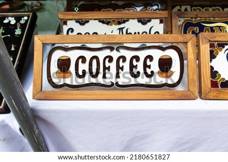 Coffee colorful wooden sign at sale in a street market at Los Sapos magic town in Puebla city, Mexico