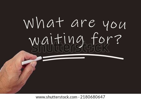 What are you waiting for question mark text written on blackboard using chalk. Motivational and inspirational concept.