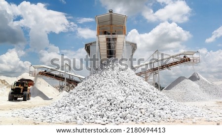 Gypsum rock or stone stacking on ground in front of the Gristmill in Gypsum mining factory with blue sky and white could background Royalty-Free Stock Photo #2180694413