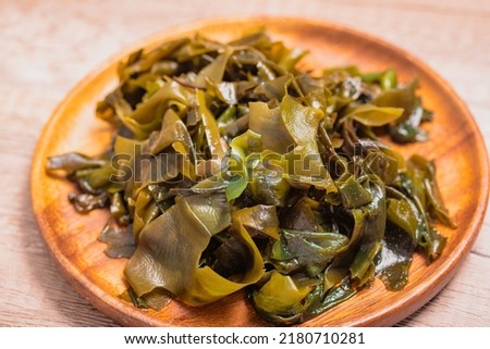 Wakame seaweed in a wooden plate. Japanese seaweed, healthy food.