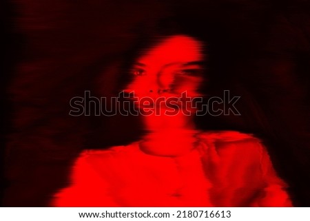 Fantasy, illusion and sci-fi concept. Abstract beautiful woman portrait in red neon futuristic glitch glowing hologram effect. Bright vivid filter applied. Pixel stretch and motion blur effect