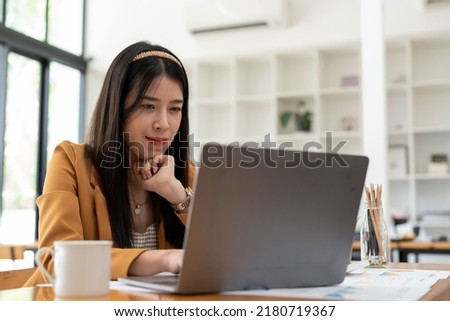 Thinking young asian entrepreneur woman in counting profit, on calculator at laptop computer, analyzing benefits, enjoying financial success, job high result, smiling