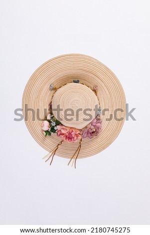 Closeup studio top view isolated shot of beautiful fashionable Asian modern classic style lady woman wicker woven weaving rattan handmade handicraft hat with dry flowers hatband on white background. Royalty-Free Stock Photo #2180745275