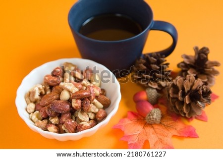 Pictures of nuts, coffee, pine cones, acorns, autumn leaves and orange background