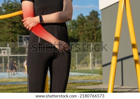 Athlete elbow pain, sports injury. Woman holding painful arm with red spot. Overuse, incident consequences. Health problems concept. High quality photo Royalty-Free Stock Photo #2180766573