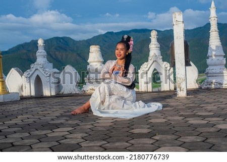 beautiful dress along with posting gestures for music, dance, performances, and Burmese arts