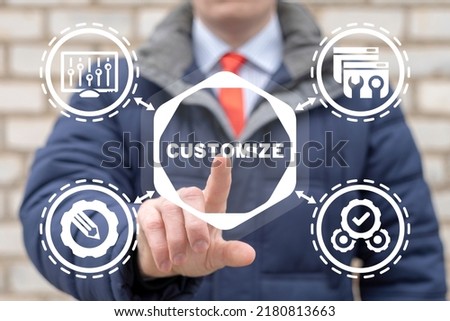 Businessman using virtual touchscreen clicks word: customize. Customization business concept. Customized product. Royalty-Free Stock Photo #2180813663