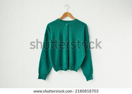 Green round neck cardigan isolated on white background. Royalty-Free Stock Photo #2180818703