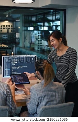 Female project supervisor explaining detail of project developing website design and coding technologies at creative office Royalty-Free Stock Photo #2180826085