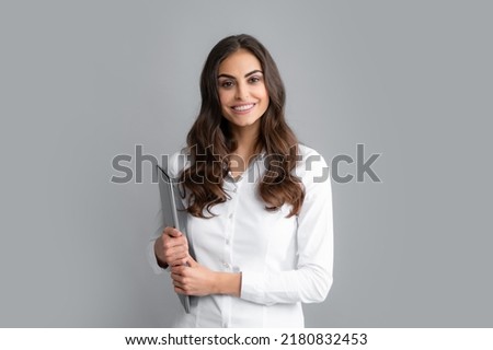 Portrait of positive cheerful ceo expert business woman work at laptop isolated over gray background. Secretary with laptop, studio portrait. Royalty-Free Stock Photo #2180832453