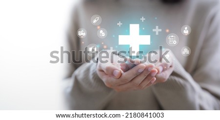 Woman hand holding plus icon for the healthcare medical icon. Health insurance health concept. access to welfare health and copy space, Royalty-Free Stock Photo #2180841003