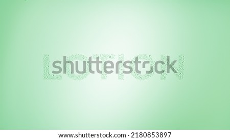 Writing lotion printed on the wet glass on green background | lotion moisturizer concept