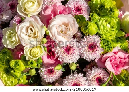 Bouquet of flowers consisting of eustoma, chrysanthemum, green rose. Floral background. Royalty-Free Stock Photo #2180866019