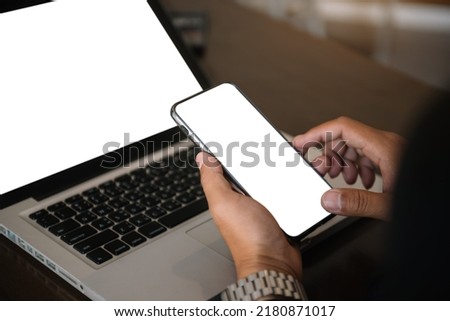Computer screen, hand Male work using smartphone and laptop.with white background for advertising, contact business search information on desk in cafe, marketing, design.