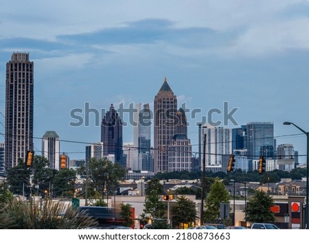 DowntownMidtown City of Atlanta Skyline showing several prominent buildings and hotels under the sky during blue hour.