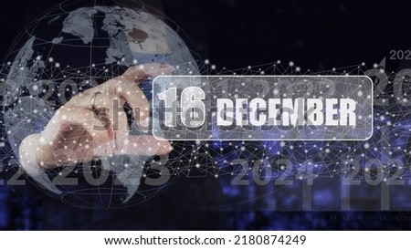December 16th. Day 16 of month, Calendar date. Hand hold virtual screen card with calendar date.  Winter month, day of the year concept
