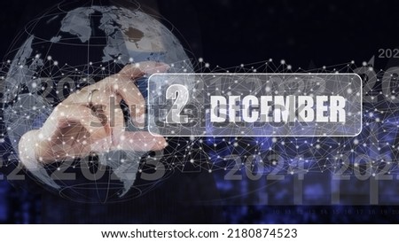 December 2nd. Day 2 of month, Calendar date. Hand hold virtual screen card with calendar date.  Winter month, day of the year concept