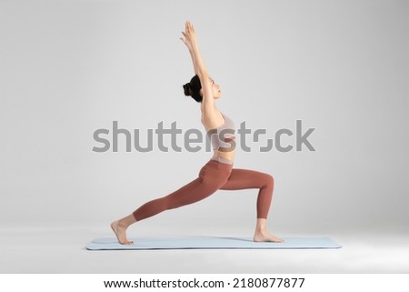 The young woman is doing yoga Royalty-Free Stock Photo #2180877877