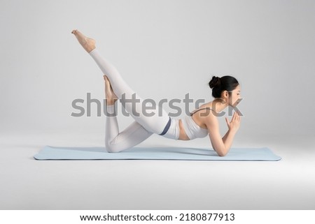 The young woman is doing yoga Royalty-Free Stock Photo #2180877913