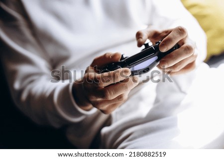 Man playing video games using joystick