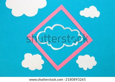 blue background with a pink frame in which there is a cloud as copy space, around the frame more clouds, creative art modern design, clean air day, blue sky, minimal concept