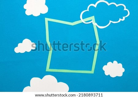 irregular frame on blue background, frame in the sky surrounded by clouds, copy space, clear air, blue sky, creative minimal design