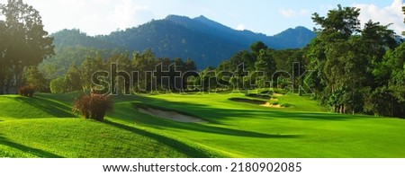A panoramic view of a green golf course in Thailand. Royalty-Free Stock Photo #2180902085